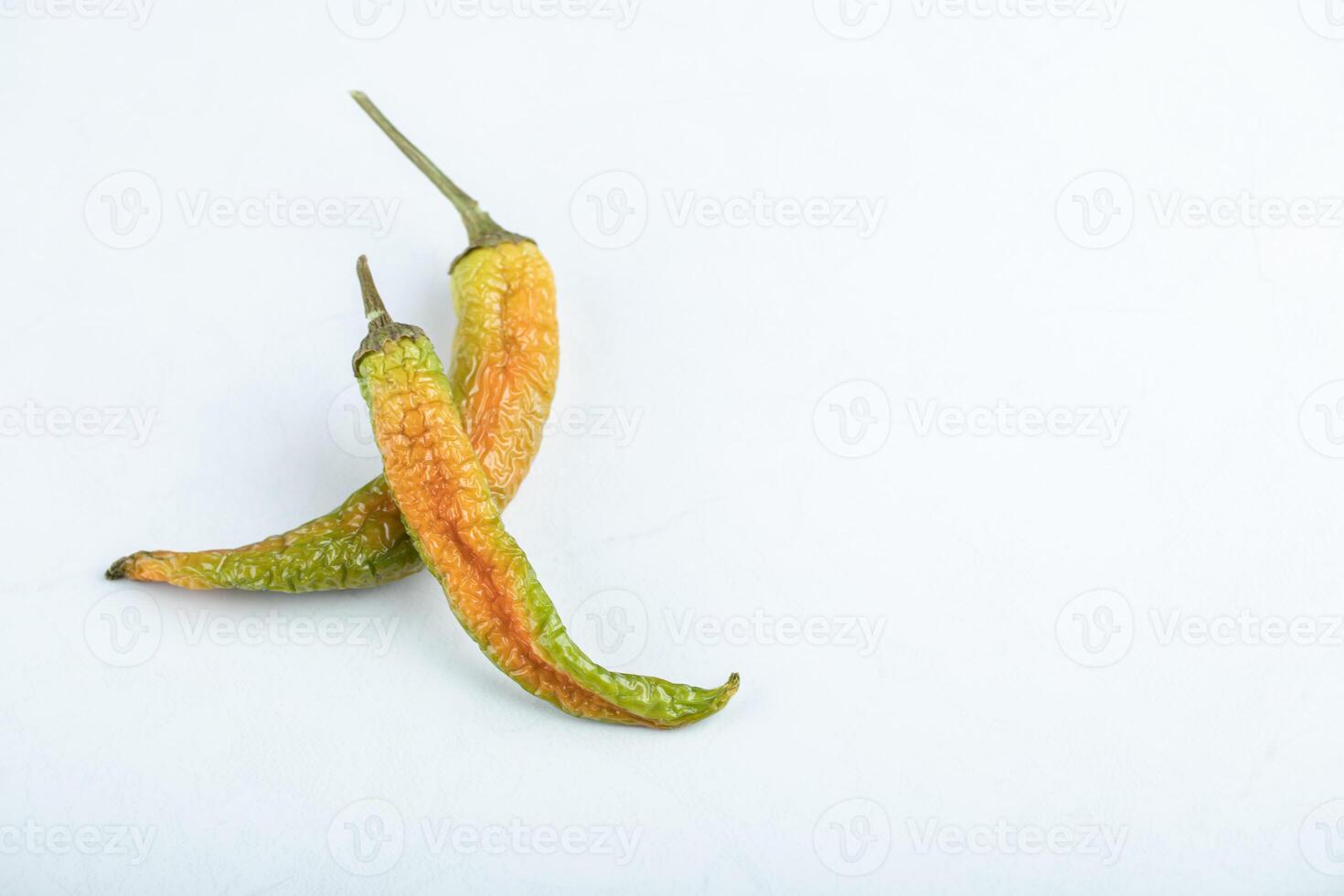 Top view of two dried green hot peppers photo