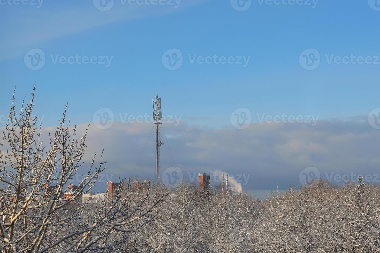 A beautiful winter landscape showcasing a telecom tower surrounded by snowcovered trees, photo