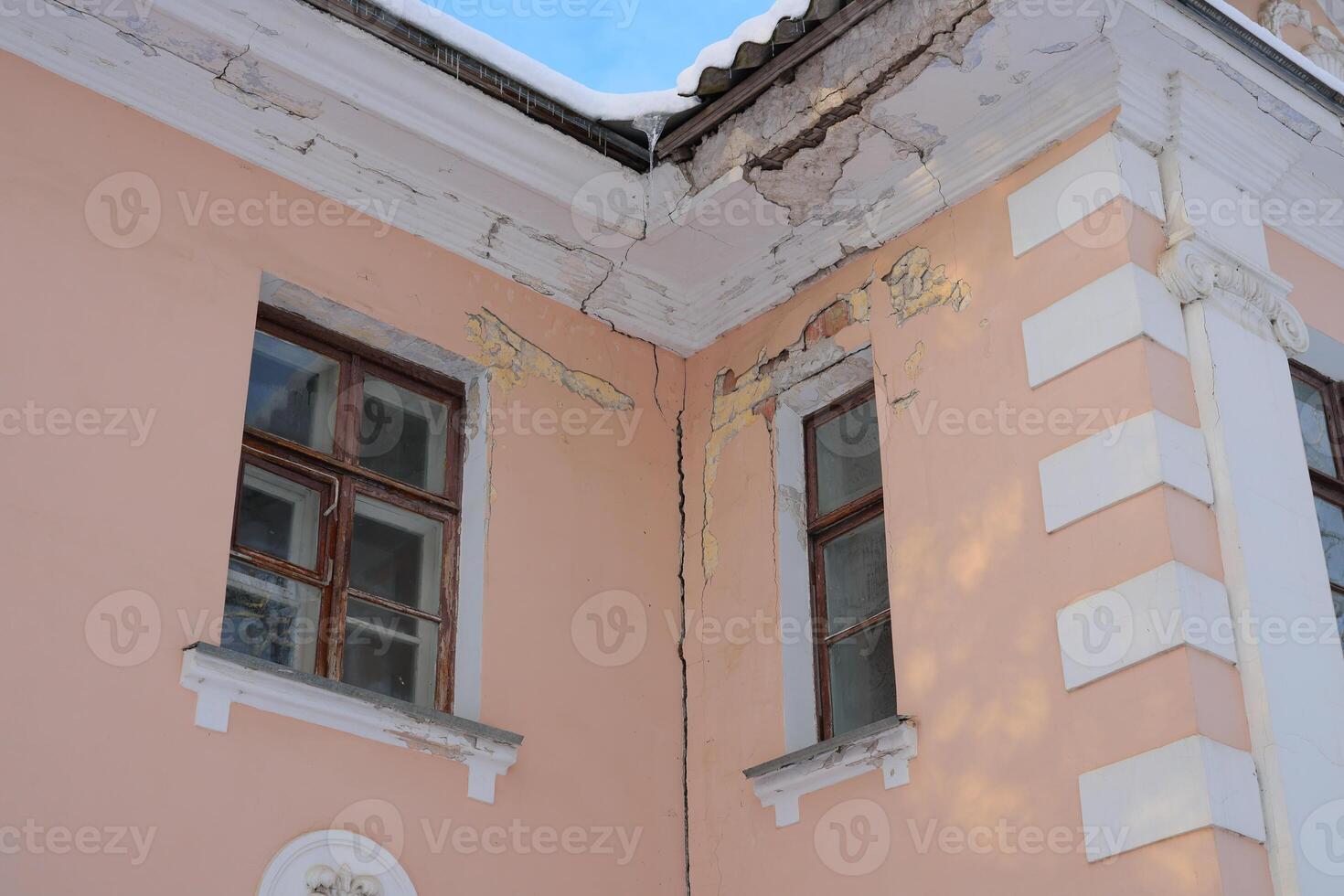 Architectural Details Highlighting the Cracks on a Corner of a Historical Building photo