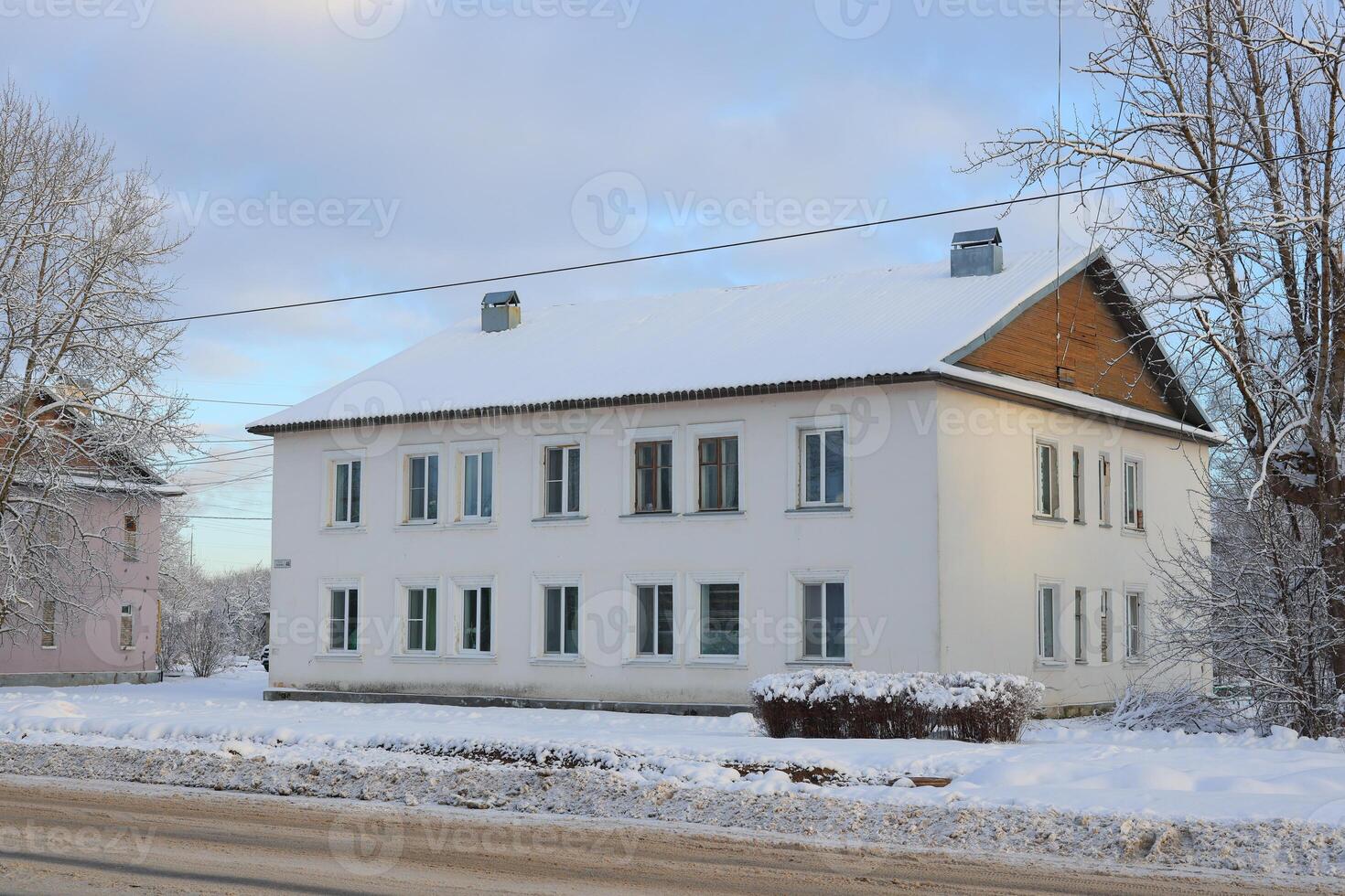 A Beautiful SnowCovered White Building Set in a Serene Winter Landscape and Scene photo