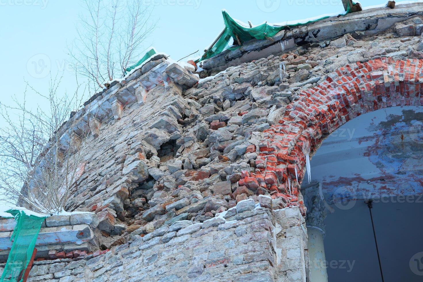 Weathered Stone Wall featuring an Archway along with Various Renovation Materials nearby photo