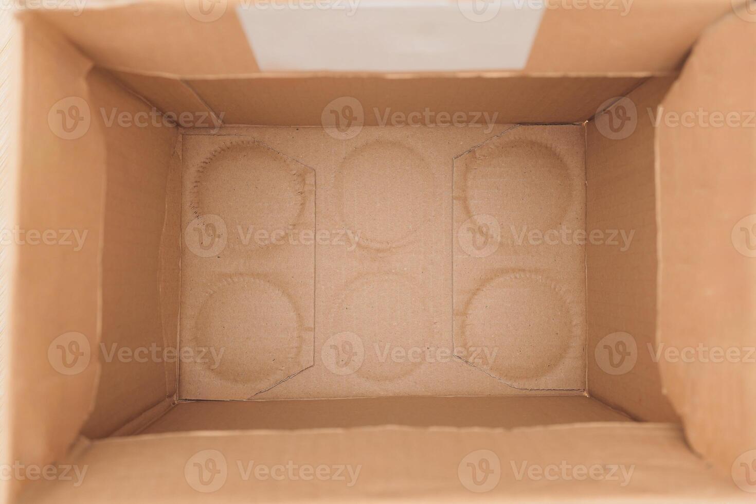 An empty cardboard box that comes with circular inserts designed for various purposes photo