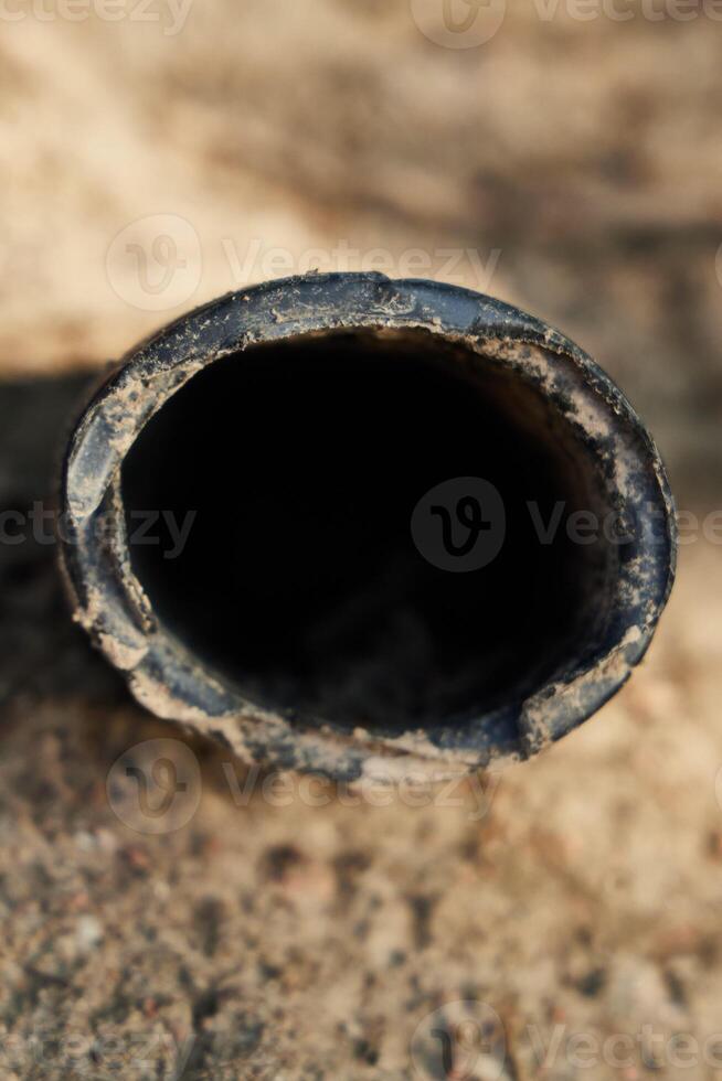 A CloseUp View of a Weathered and Rusty Pipe Found in Untamed Natural Surroundings photo