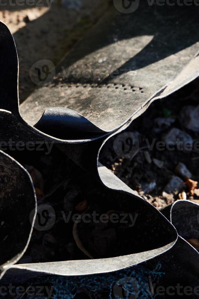 Exploring Abstract Patterns Found in Curved Rubber Surfaces Illuminated by Natural Light photo