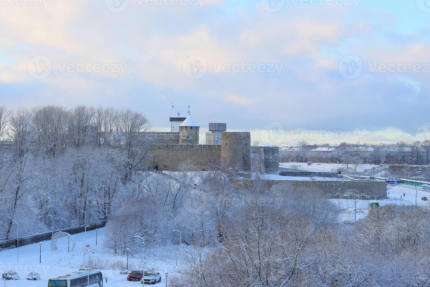A winter scene shows a historic fortress surrounded by snow, creating a serene atmosphere photo