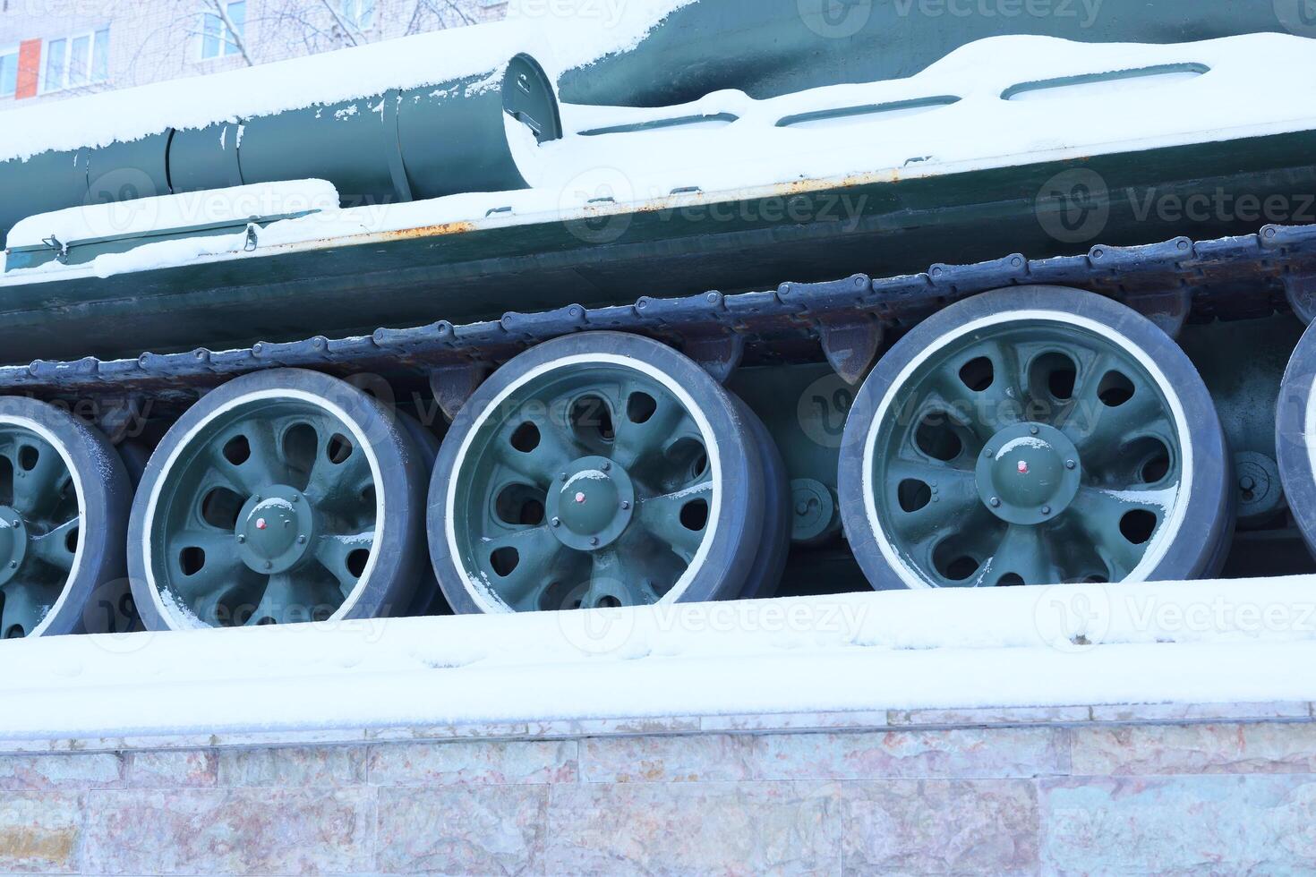 The tank wheels stand out beautifully in a stunning snowy setting, highlighting their importance photo