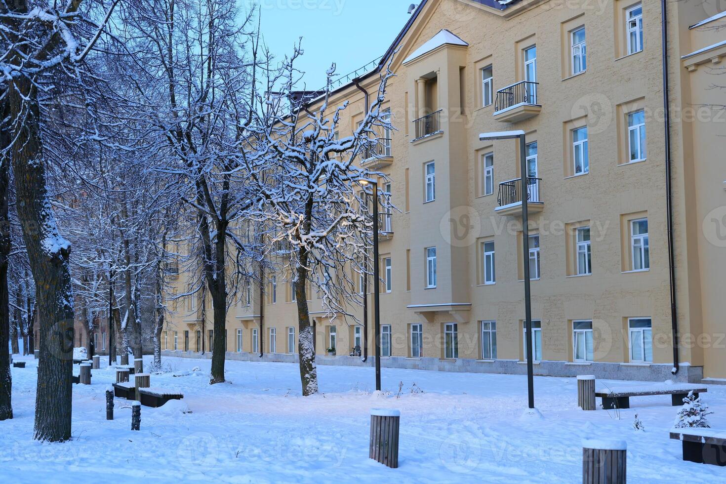 A Serene and Peaceful Winter Scene Featuring SnowCovered Buildings in a Charming Setting photo