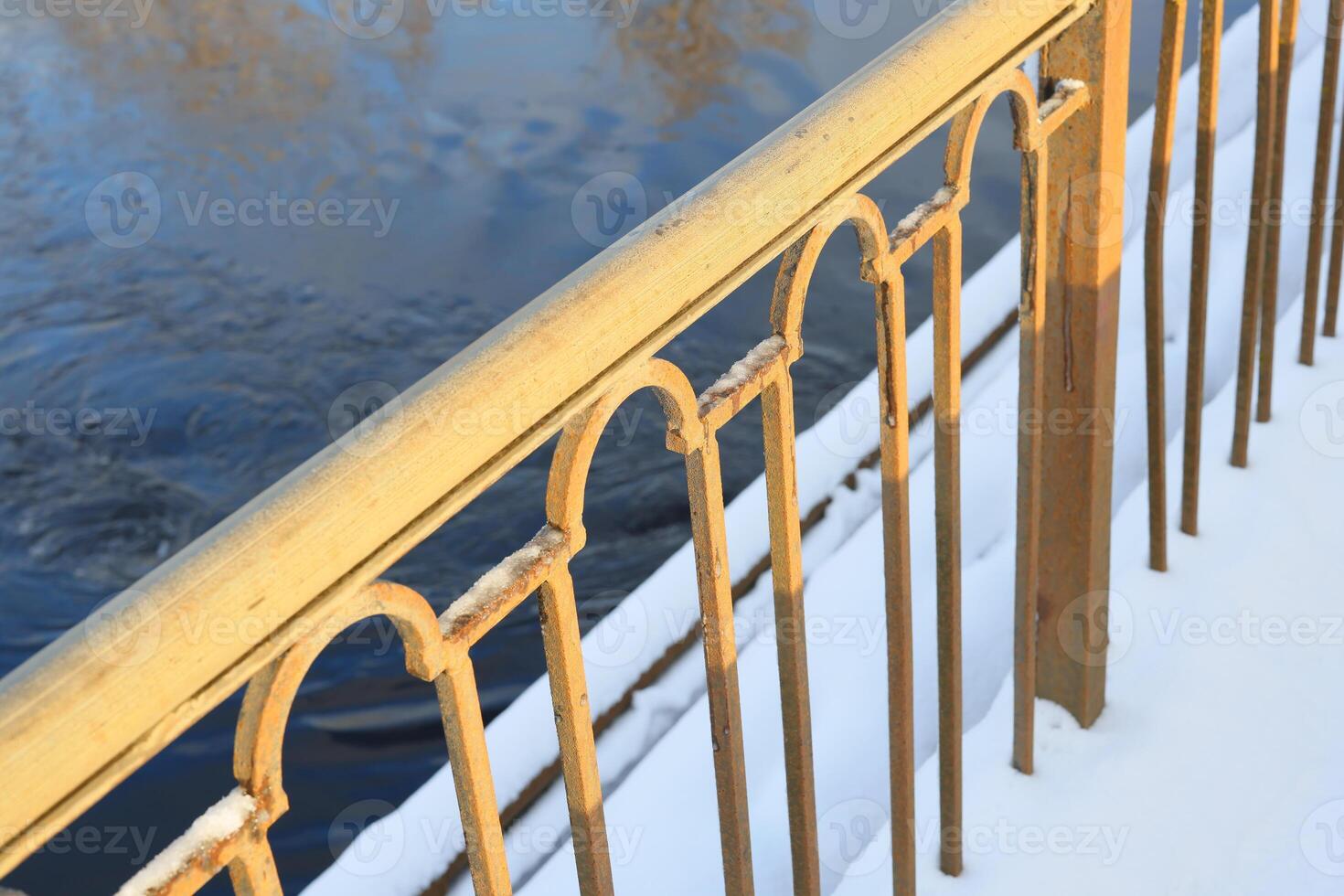 Golden Railing Set Against Calm Waters in a Serene Winter Landscape and Setting Atmosphere photo