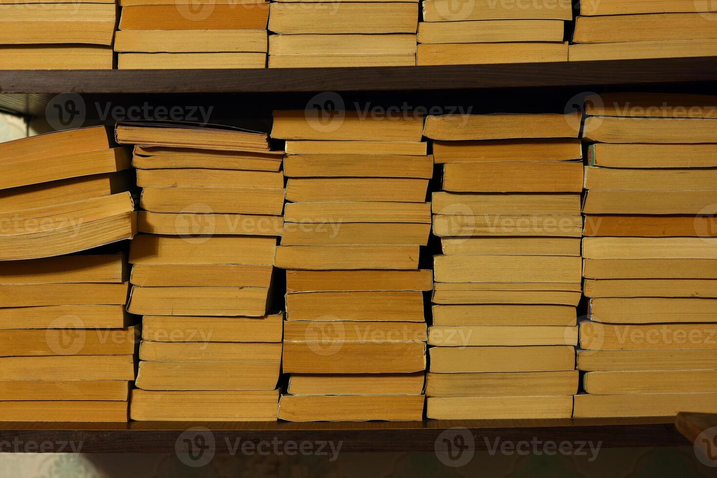 A collection of stacked books on a shelf captures the essence of knowledge and imagination photo