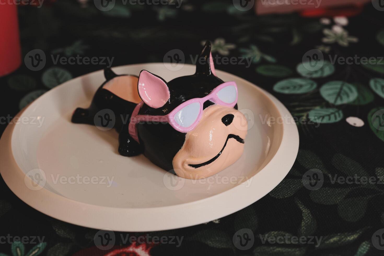 Adorable Dogshaped Cake Wearing Stylish Sunglasses Beautifully Arranged on a Plate photo