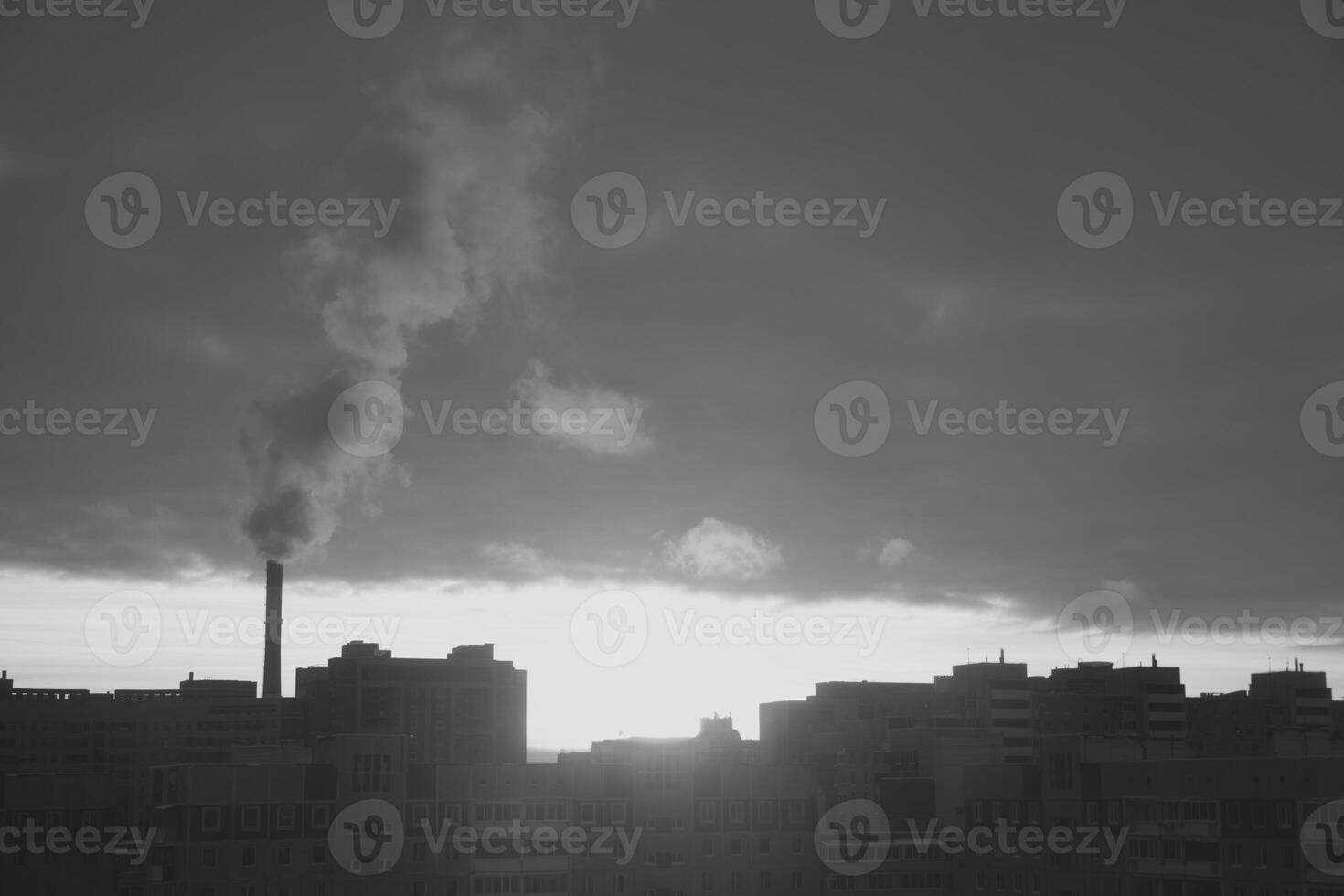 A dusk view of an industrial cityscape with heavy smoke emissions, symbolizing urban growth photo