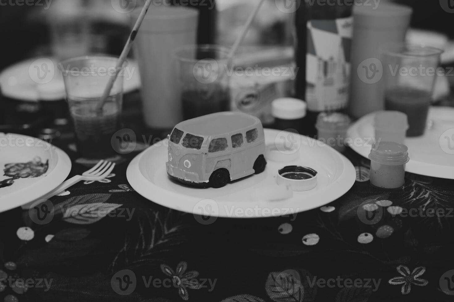 A Vibrant Arts and Crafts Table Featuring a Fun Van Model for Creative Activities and Play photo