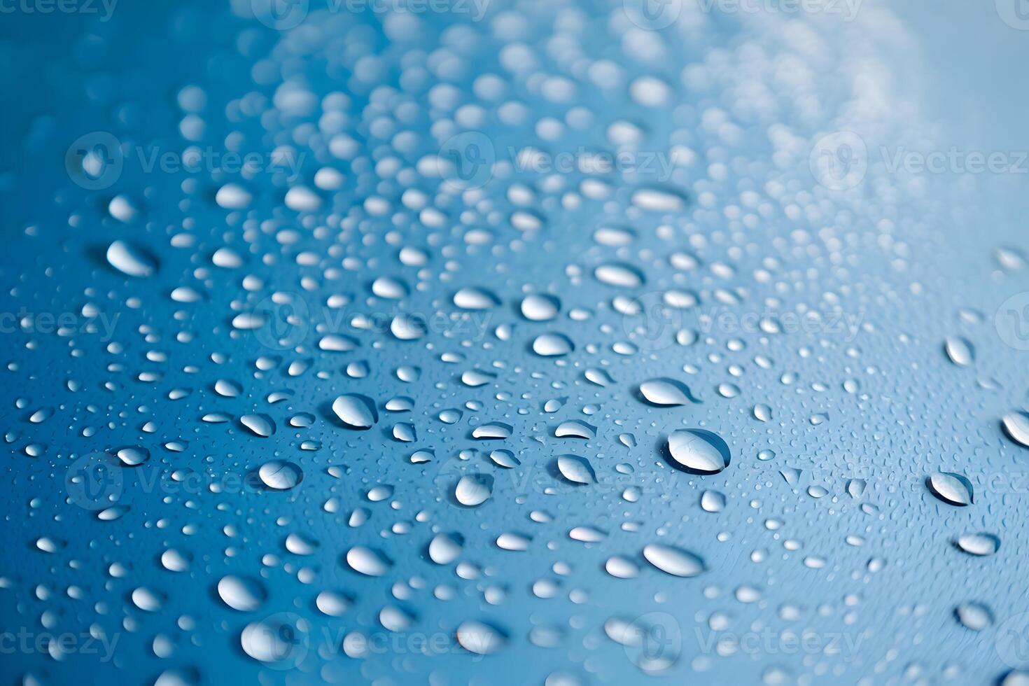 Glistening water droplets on blue surface create sparkling, gradient visual effect photo