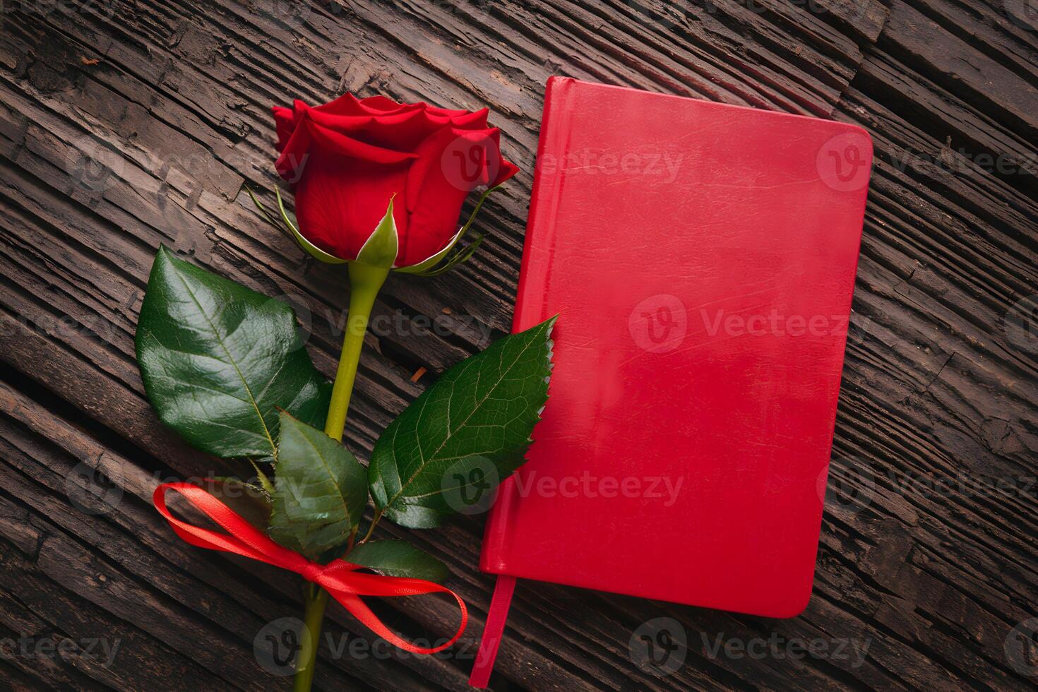 Red rose with notebook on rustic wooden background creates romantic elegance photo