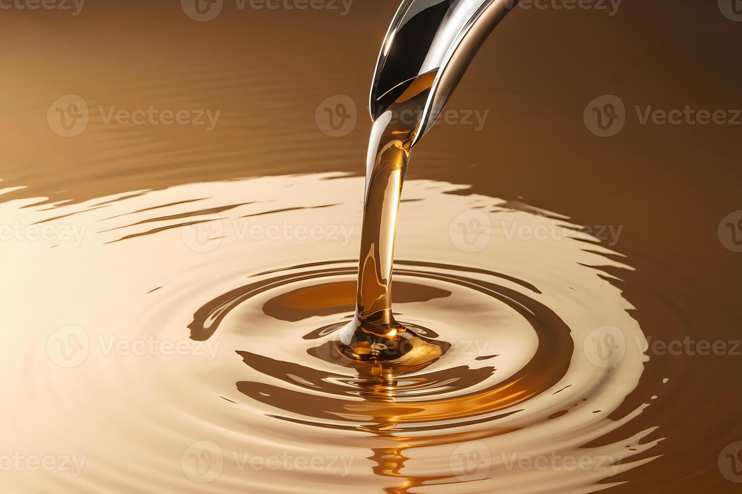 Golden liquid pouring from spout across glossy surface, transitioning in warm shades photo