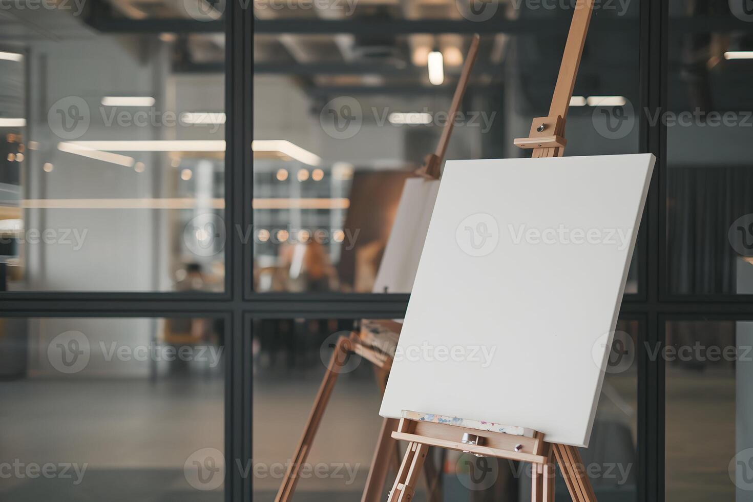 Blank Canvas on Wooden Easel Reflecting Indoor Depth and Glass Partition photo