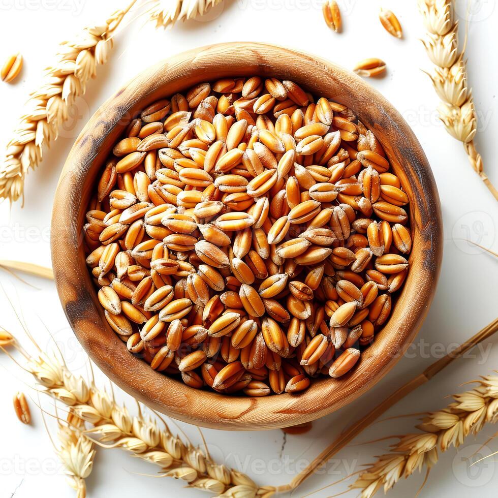 Ears of wheat in a wooden bowl on a white background, top view photo