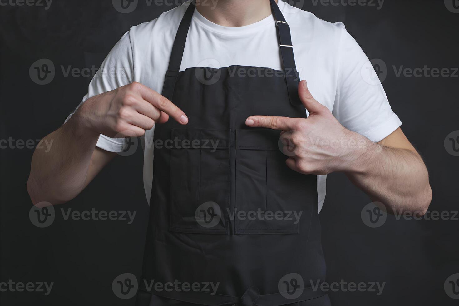 White T shirt, black apron, practical design emphasized against dark simple background photo