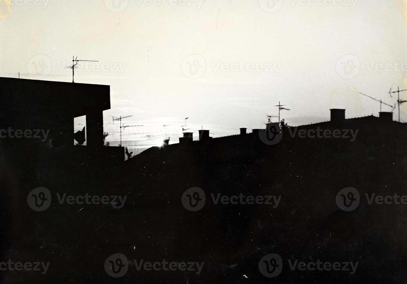 A black and white photo of a building with a sky in the background