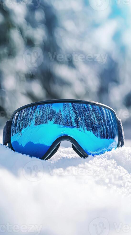 Winter Ski Goggles Reflecting Snowy Mountain Scenery photo