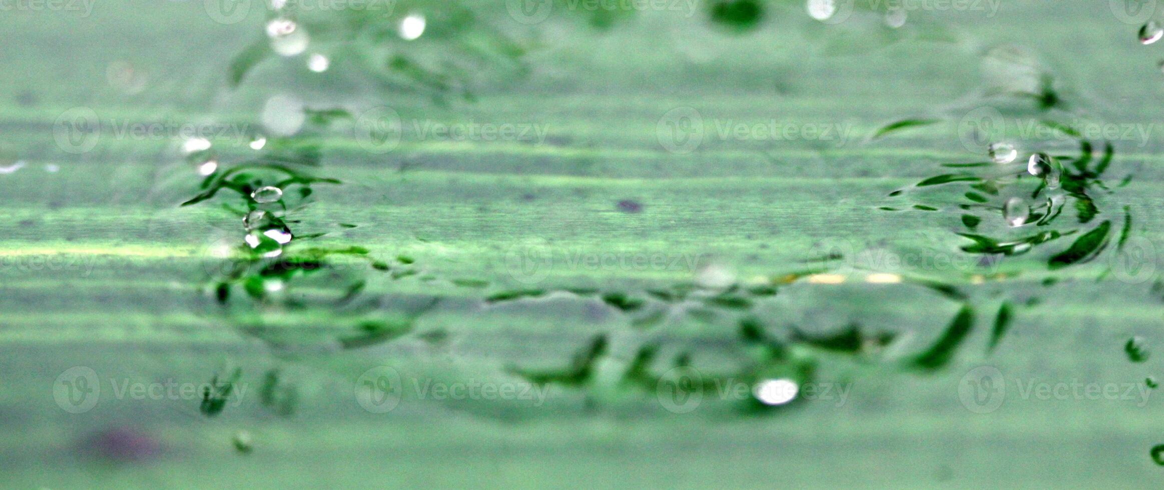 Water droplets on a green background photo