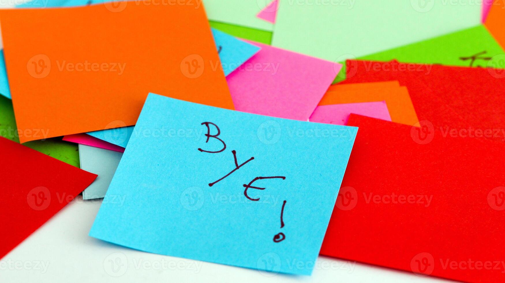 A pile of colorful post-it notes with the word bye written on them photo
