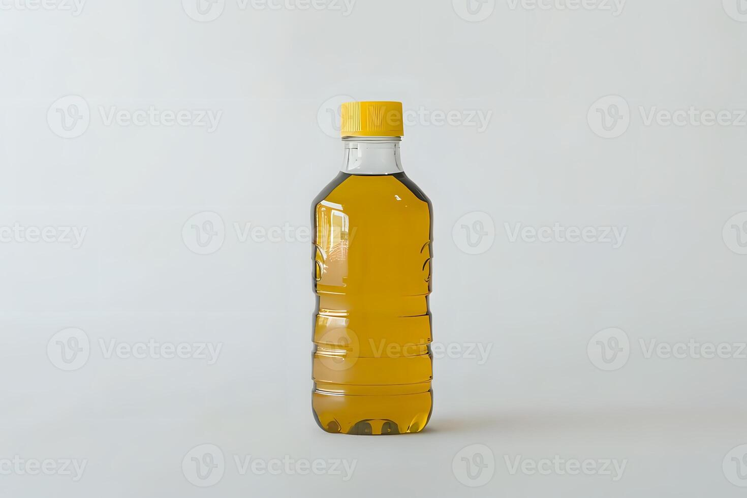 A Clear Plastic Bottle Filled with Golden Yellow Cooking Oil, Sealed with a Yellow Cap, Stands Against a Plain White Background. A Guide to Culinary Oils and Their Uses in the Kitchen photo