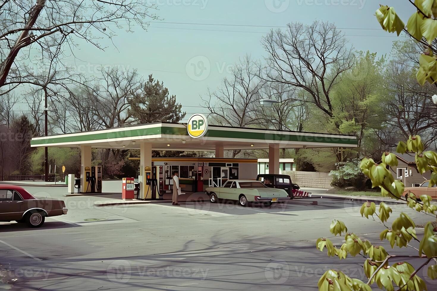 Vintage Gas Station Scene. Classic Cars Refuel at a Retro Filling Station Under a Canopy of Trees in Springtime, Showcasing Nostalgic Automotive and Architectural Design. photo