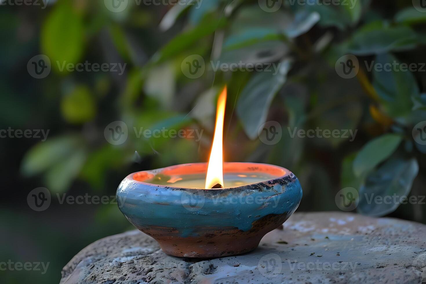 Serene Candlelight. A Ceramic Vessel Holds a Flickering Flame, Illuminating the Tranquil Natural Surroundings with Gentle Warmth, Creating a Peaceful Atmosphere in the Garden. Find Inner Peace photo