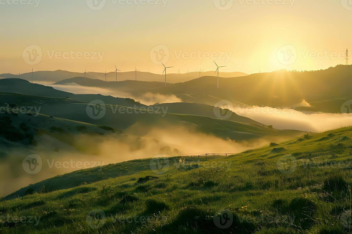 Sunrise over Rolling Hills. Wind Turbines and Misty Meadows at Dawn, A Picturesque Landscape of Green Pastures and Golden Light, Creating a Serene and Tranquil Atmosphere. photo