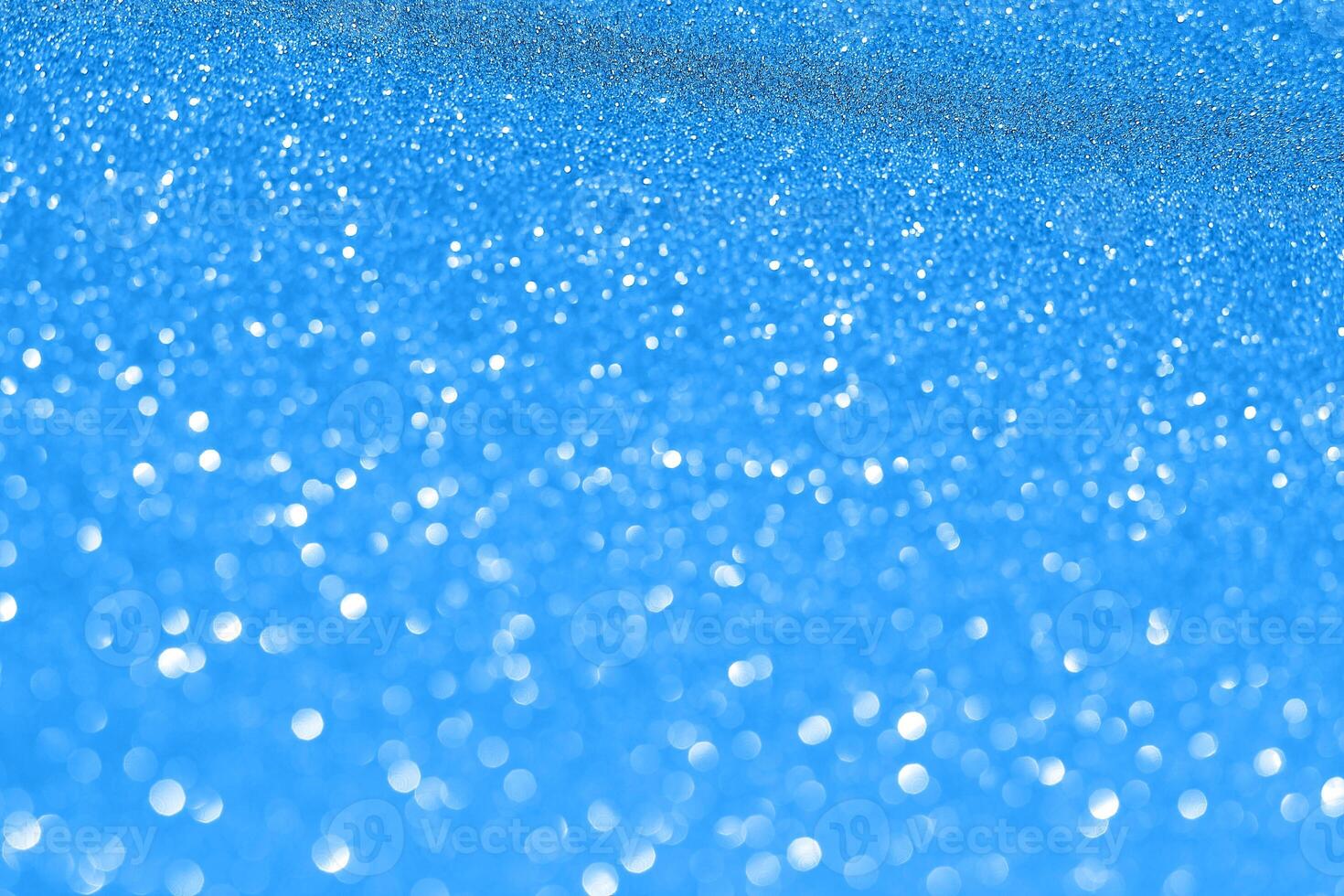 Blue background with snow falling from the sky photo