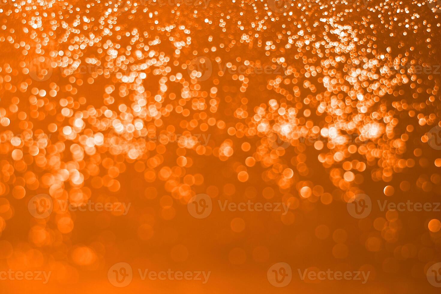 A close up of a bright orange background with sparkles photo
