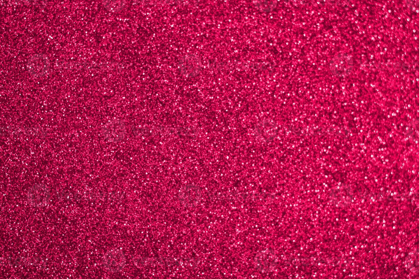 A red glittery background with a lot of glitter photo