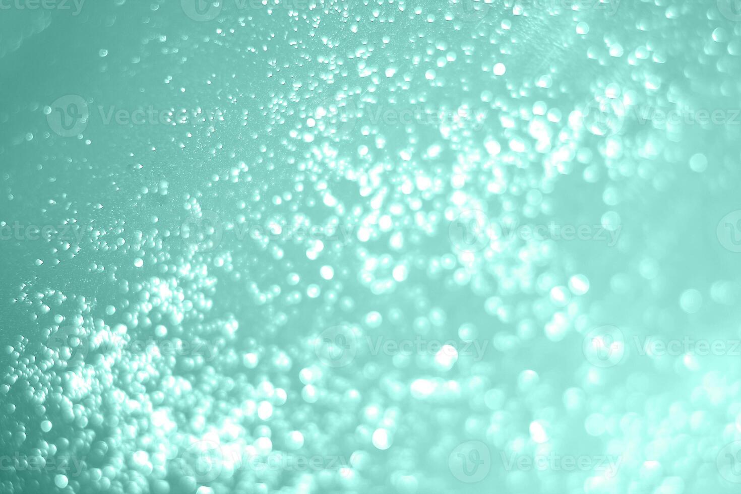 A close up of bubbles in a blue liquid photo
