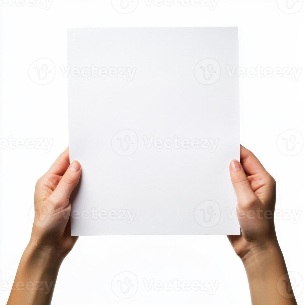 Hands hold a blank sheet of paper against a white background in a minimalist setting photo