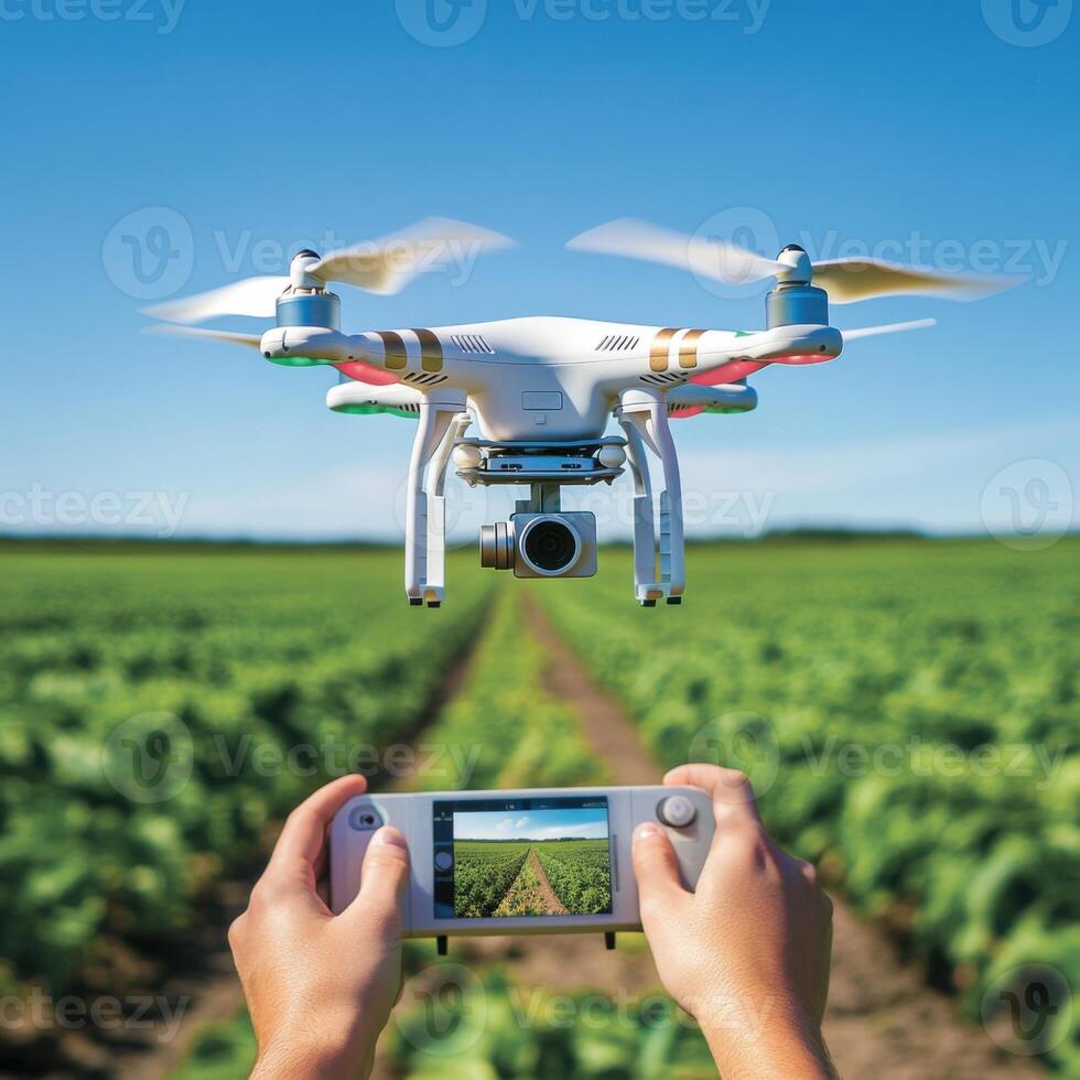 Drone captures aerial view of a lush vineyard while operator monitors from a handheld device in bright daylight photo