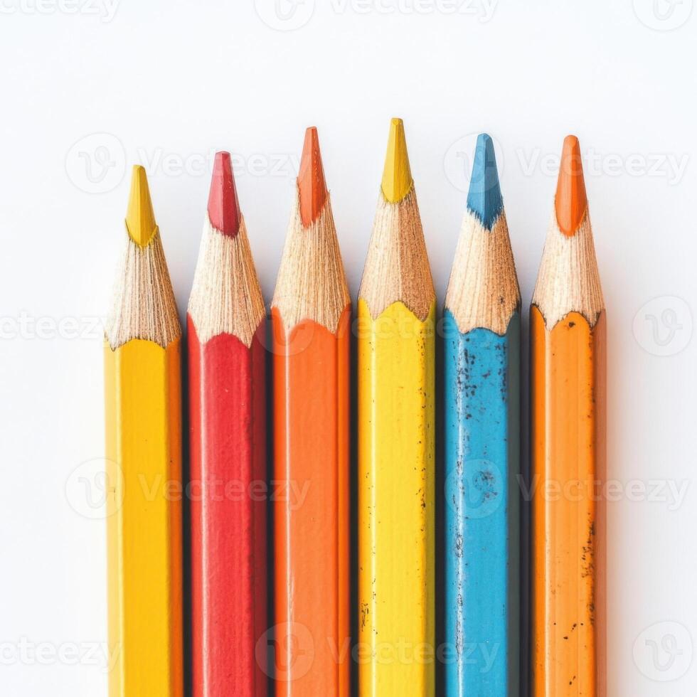 Colorful collection of sharpened pencils arranged neatly on a white surface for art and creativity photo