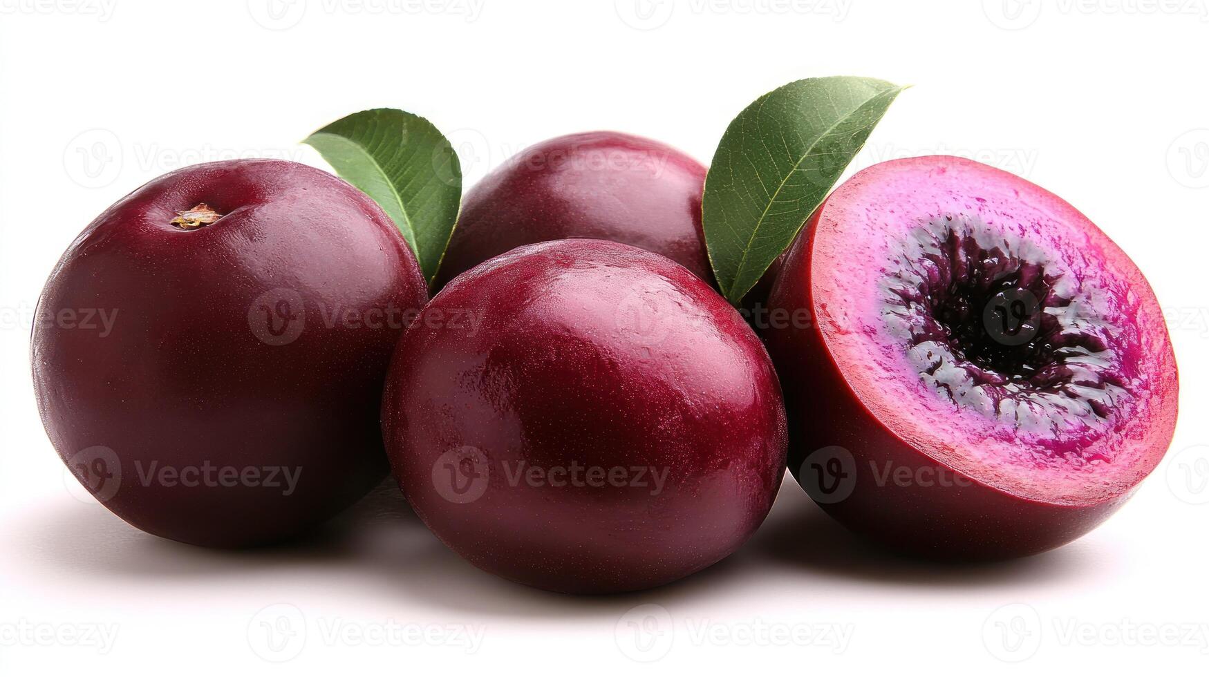 Fresh, dark purple plums are arranged with one sliced open, showcasing their vibrant interior photo