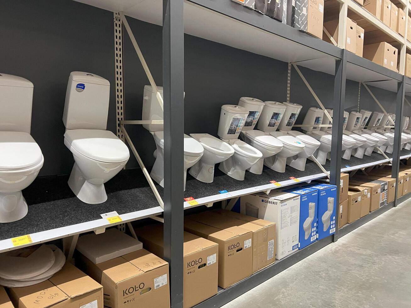 Kyiv, Ukraine - January 03, 2025 Large display of modern toilets in a professional bathroom showroom setting photo