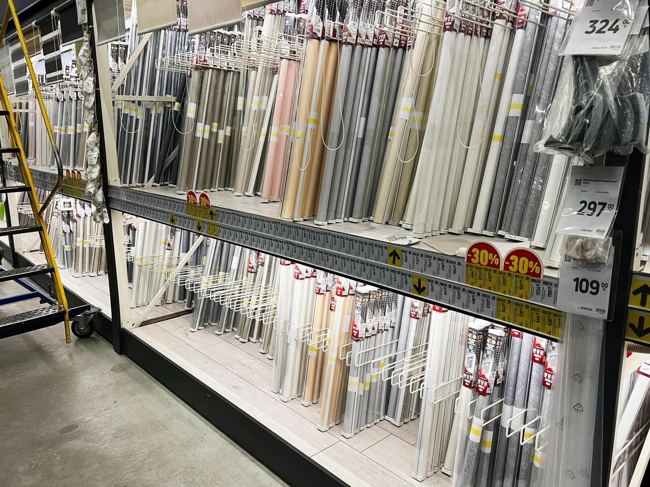 Kyiv, Ukraine - January 03, 2025 Assorted window blinds displayed on shelves in a store aisle photo