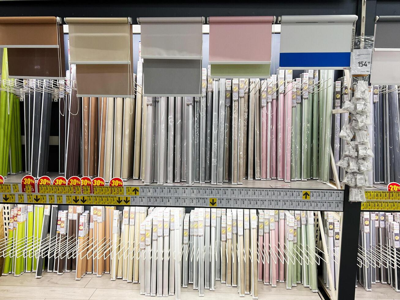 Kyiv, Ukraine - January 03, 2025 Assorted Window Blinds and Shades Displayed on a Store Shelf with Discounts photo