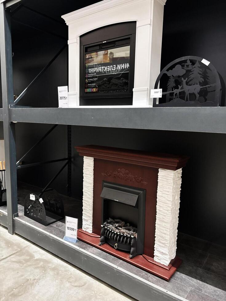 Kyiv, Ukraine - January 03, 2025 Electric fireplaces displayed on retail shelving in a store setting photo