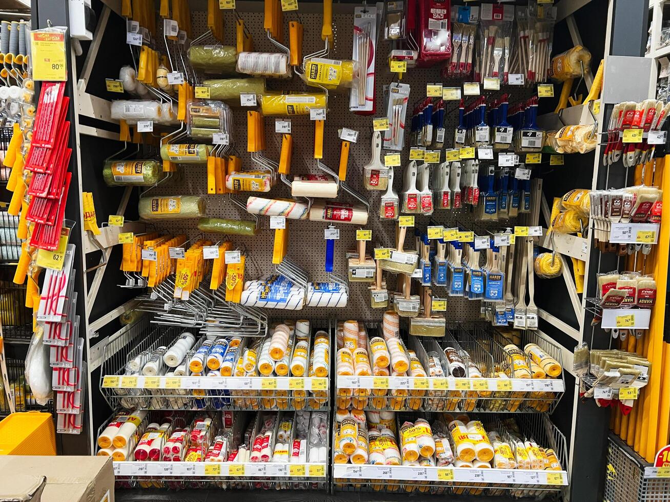 Kyiv, Ukraine - January 03, 2025 Various paint tools and accessories displayed on shelves in a hardware store photo
