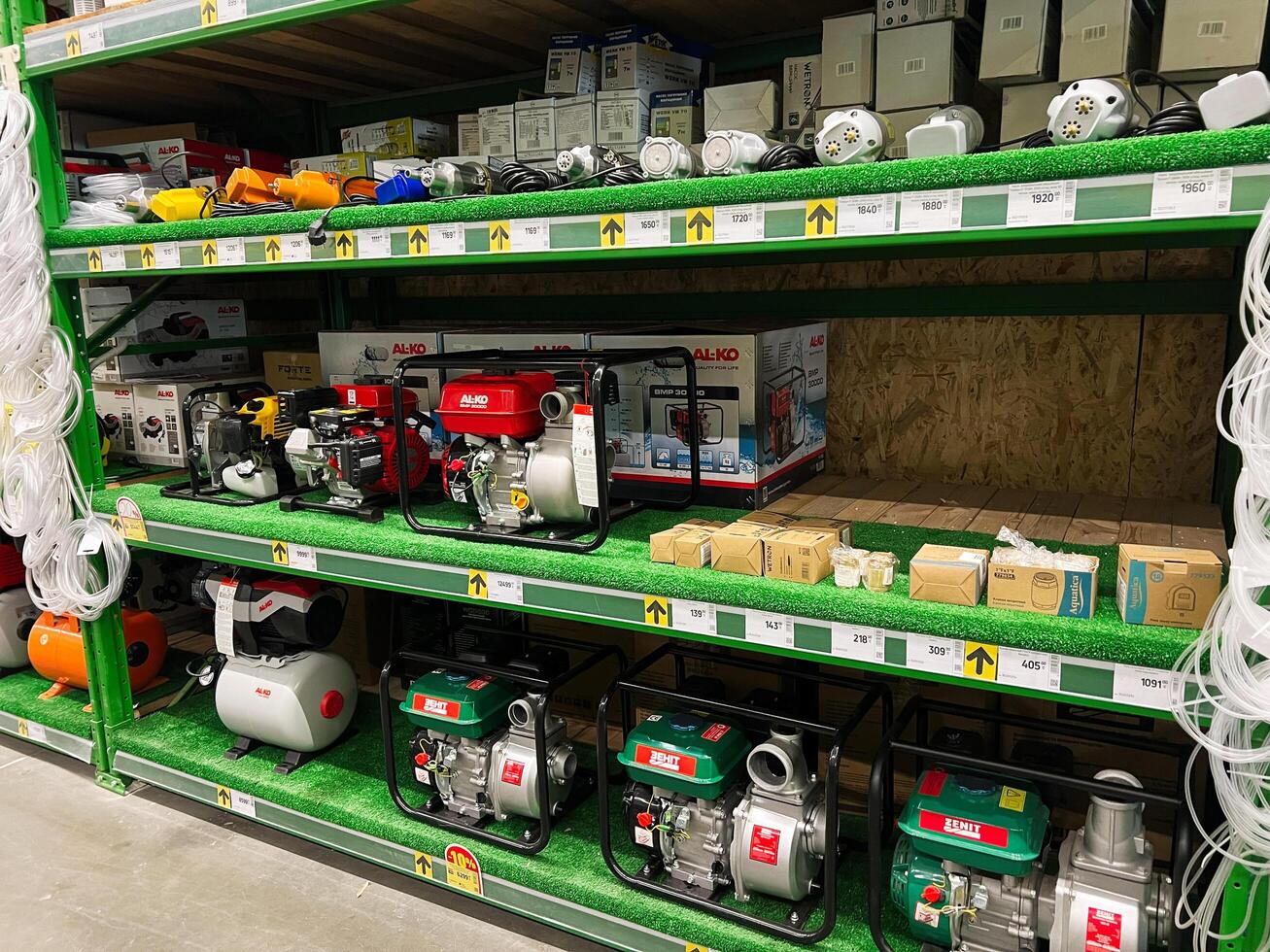 Kyiv, Ukraine - January 03, 2025 Row of water pumps and accessories displayed on store shelves photo