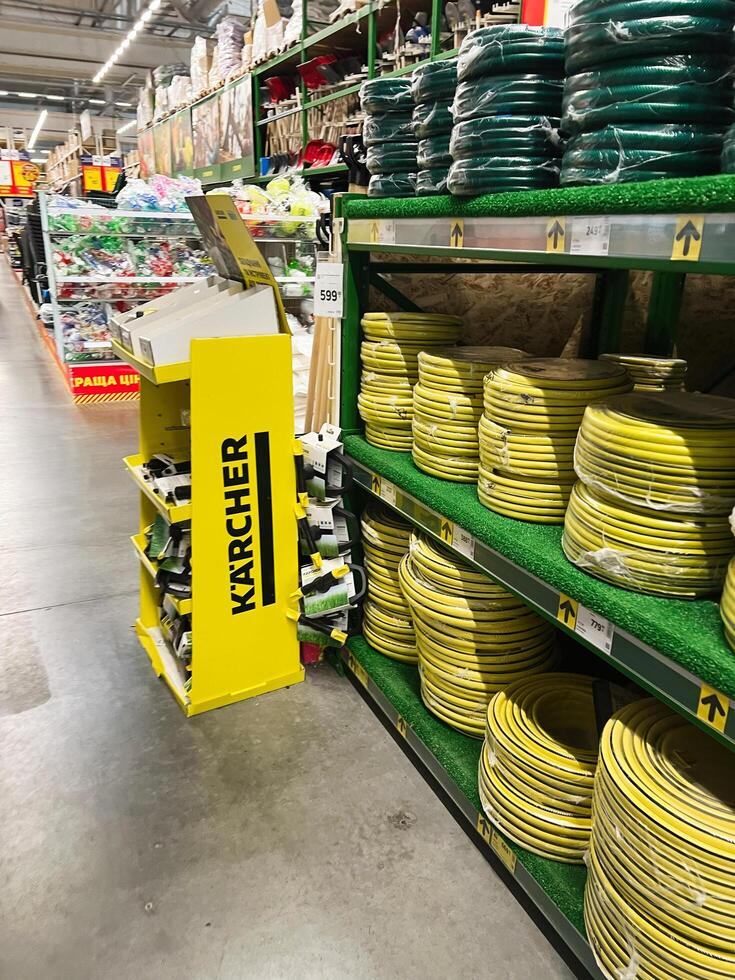 Kyiv, Ukraine - January 03, 2025 Store aisles with shelves displaying garden hoses and equipment for sale photo