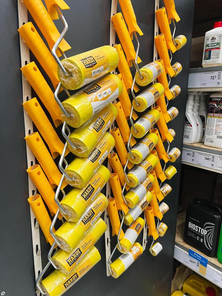 Kyiv, Ukraine - January 03, 2025 Colorful display of paint rollers arranged on store shelf photo