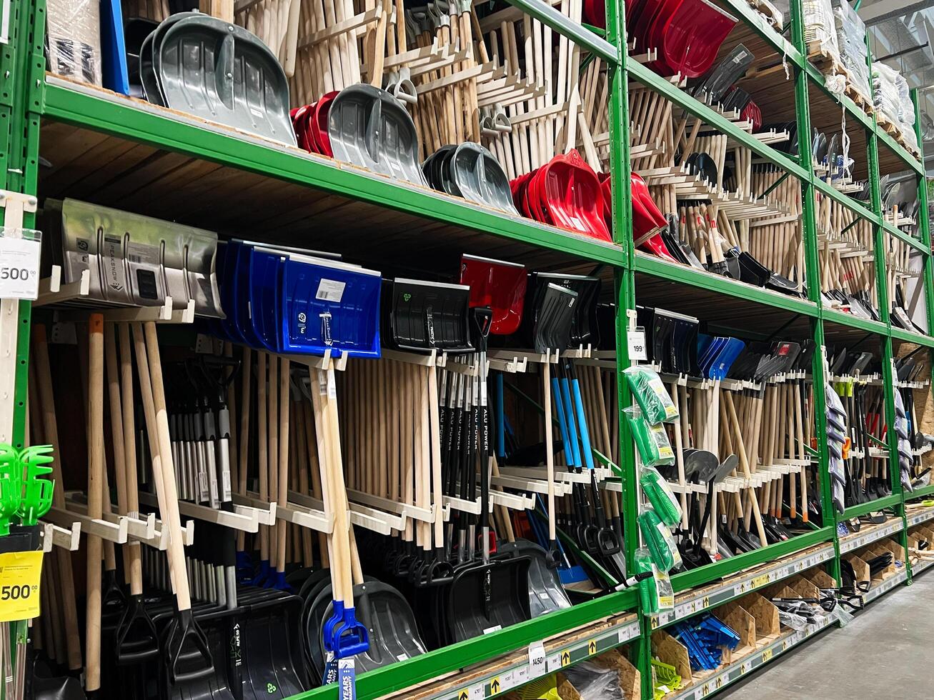 Kyiv, Ukraine - January 03, 2025 Shelves of snow shovels neatly displayed in a hardware store photo