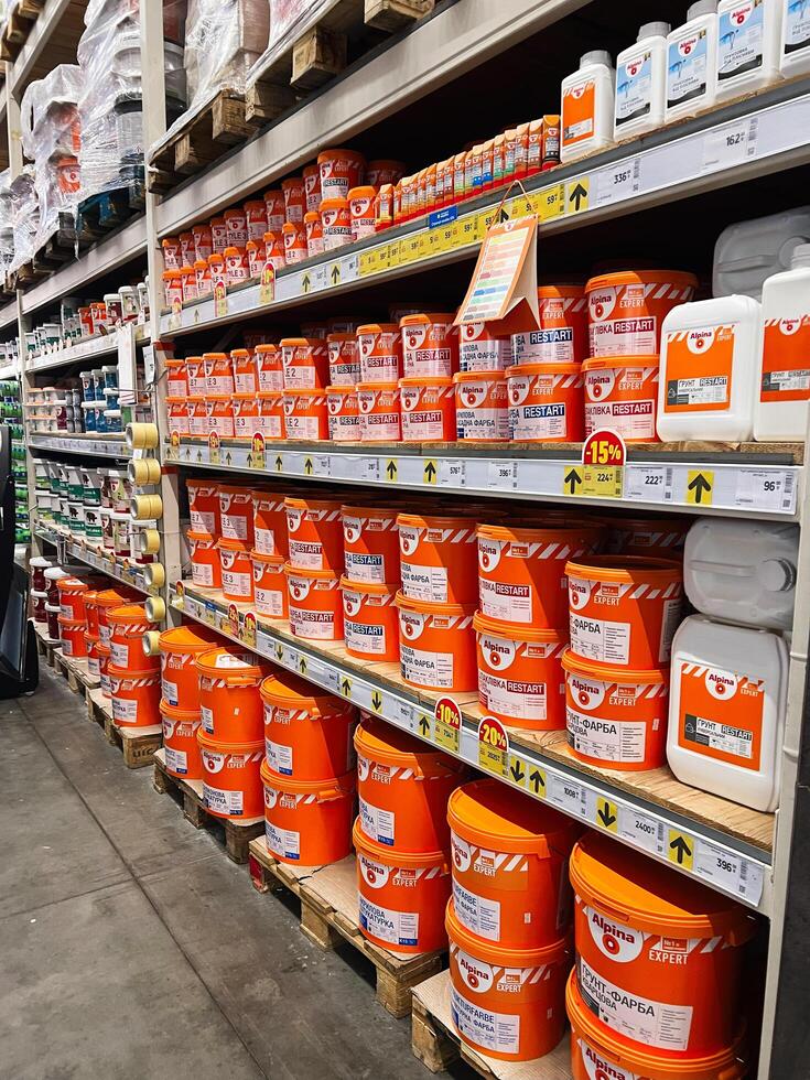 Kyiv, Ukraine - January 03, 2025 Shelves stocked with vibrant paint buckets in an organized store display photo