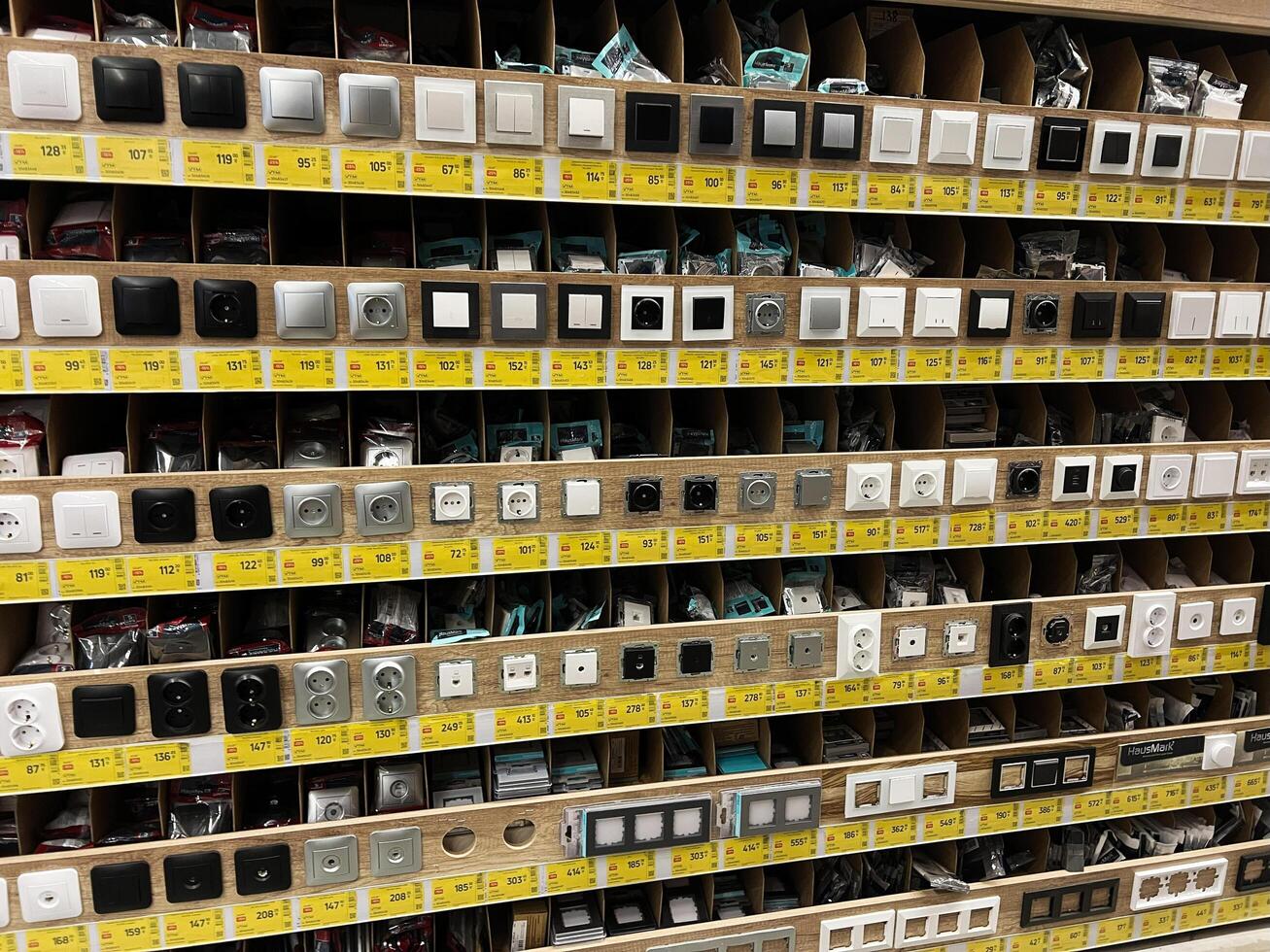 Kyiv, Ukraine - January 03, 2025 Assortment of Electrical Switches and Sockets in a Store Display Shelf photo
