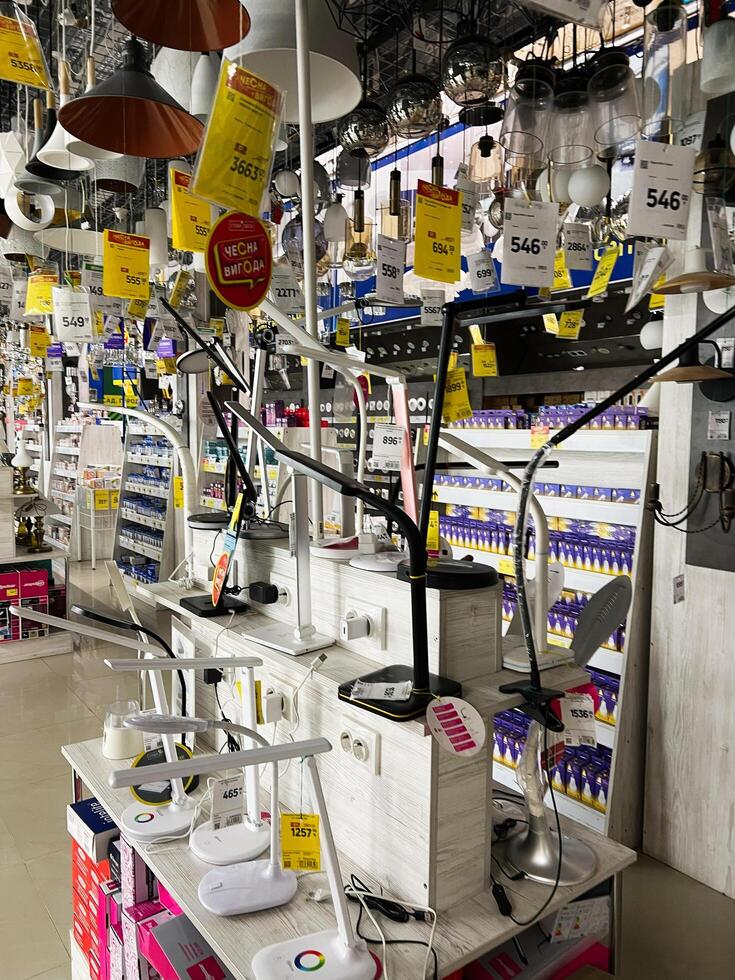 Kyiv, Ukraine - January 03, 2025 Selection of modern tabletop and hanging lamps displayed in a store interior photo